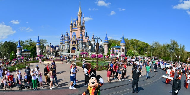 Mickey Mouse waves to fans during a parade at Walt Disney World Resort on March 3, 2022 in Lake Buena Vista, Florida.