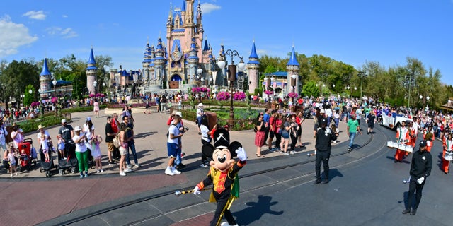 Mickey Mouse waves to fans during a parade at Walt Disney World Resort on March 03, 2022, in Lake Buena Vista, Florida.