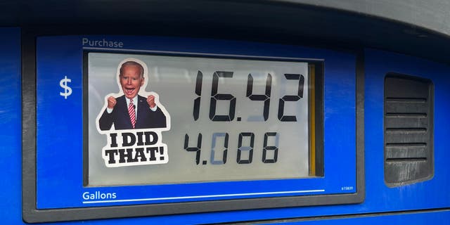 A sticker of President Joe Biden is placed on a gas pump at an Exxon Station on March 9, 2022, in Lakewood, Colorado.