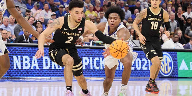 Sahvir Wheeler #2 of the Kentucky Wildcats and Scotty Pippen Jr. #2 of the Vanderbilt Commodores reach for a loose ball during the quarterfinals of the 2022 SEC Men's Basketball Tournament at Amalie Arena on March 11, 2022 in Tampa, Florida.