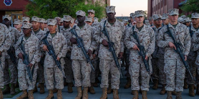 United States Marine Corps recruits participate in the traditional Eagle, Globe and Anchor medal ceremony.  (Photo by Robert Nickelsberg/Getty Images)