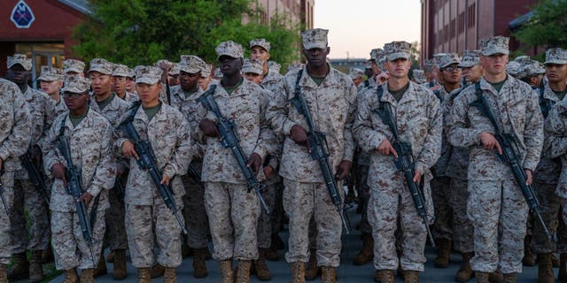 US Marine Corps recruits take part in the traditional Eagle, Globe and Anchor medal ceremony. (Photo by Robert Nickelsberg/Getty Images)