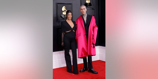 Kourtney Kardashian and Travis Barker attend the 64th Annual Grammy Awards.