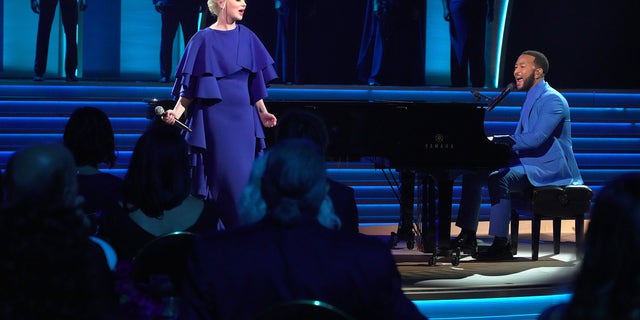 Mika Newton and John Legend perform onstage during the 64th Annual Grammy Awards.