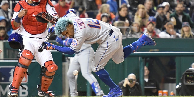 Francisco Lindor (12) of the New York Mets is hit by a pitch thrown by Steve Cishek of the Washington Nationals at Nationals Park April 8, 2022, in Washington, D.C.
