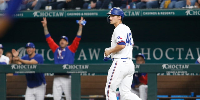 Corey Seager (5) of the Texas Rangers walks to first base after he was intentionally walked to drive in a run in the fourth inning against the Los Angeles Angels at Globe Life Field on April 15, 2022, in Arlington, Texas.  