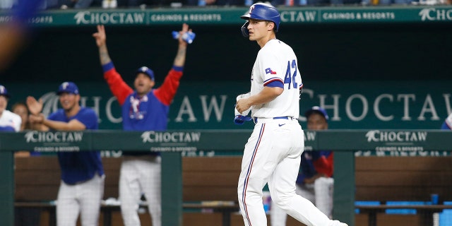 Corey Seager (5) of the Texas Rangers walks to first base after he was intentionally walked to drive in a run in the fourth inning against the Los Angeles Angels at Globe Life Field on April 15, 2022, in Arlington, Texas.