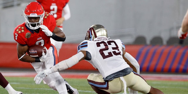 Trey Williams #3 of New Jersey Generals runs with the ball as Jalin Burrell #23 of Michigan Panthers defends in the second quarter of the game at Protective Stadium on April 22, 2022 in Birmingham, Alabama. 