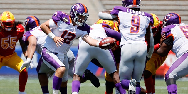 Josh Love #12 of Pittsburgh Maulers hands off the ball to Madre London #9 in the fourth quarter of the game against the Philadelphia Stars at Protective Stadium on April 23, 2022 in Birmingham, Alabama. 