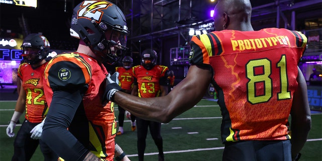 Johnny Manziel #2 and Terrell Owens #81 of Zappers shake hands before the game against the Glacier Boyz during Fan Controlled Football Season v2.0 - Week Two on April 23, 2022 in Atlanta, Georgia.
