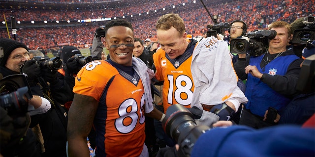 Denver Broncos QB Peyton Manning (18) with Demaryius Thomas (88) after winning game vs New Engalnd Patriots at Sports Authority Field at Mile High in Denver, Colorado, on January 24, 2016.