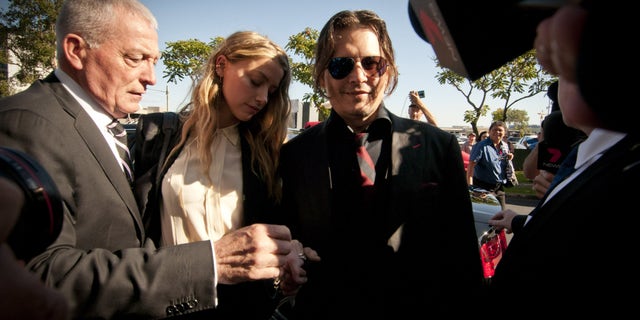 Amber Heard, and Johnny Depp leave Southport Magistrates Court, Queensland, April 18, 2016. At the time, Heard received a fine for bringing pet dogs, Pistol and Boo, illegally into Australia in 2015. Now, Depp and Heard are locked into a court battle of their own against each other.