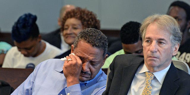 Darryl Anthony Howard (left) wipes away tears after Judge Orlando Hudson rules to vacate his murder conviction on Wednesday, Aug. 31, 2016.