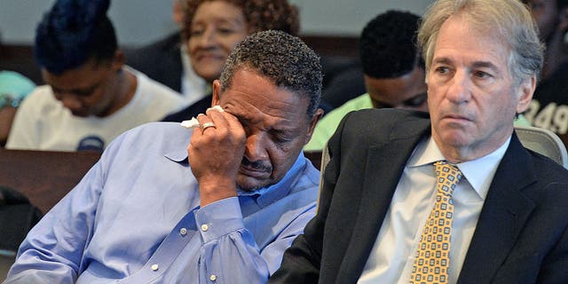 Darryl Anthony Howard (left) wipes away tears after Judge Orlando Hudson rules to vacate his murder conviction on Wednesday, Aug. 31, 2016.