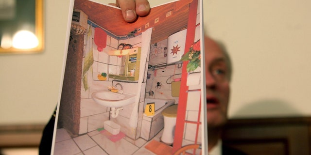 Colonel Franz Polzer, chief investigator of the district of Lower Austria shows a detail picture of the cellar appartment, where a father imprisoned his daughter for 24 years and had seven children with her, during a press conference on April 28, 2008.