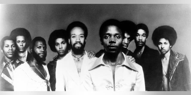 L to R: Johnny Grahm, Larry Dunn, Andrew Woolfolk, Al McKay, Maurice White, Philip Bailey, Verdine White, Freddy White, Ralph Johnson.