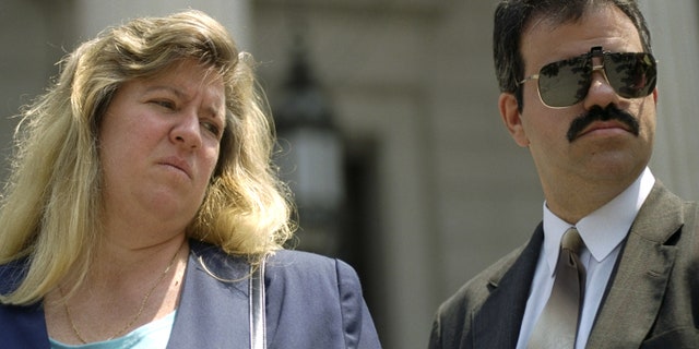 Donna and Richard Fasano leaving court. Donna Fasano gave birth to two boys, one black and one white, when a doctor implanted another couples embryo into her uterus.