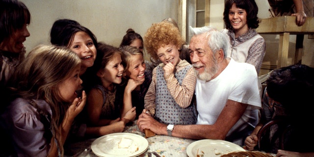 John Huston, director, with Aileen Quinn and other cast members of 