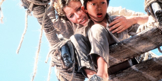 Kate Capshaw holds onto Ke Huy Quan over a broken bridge in a scene from the film "Indiana Jones And The Temple Of Doom."