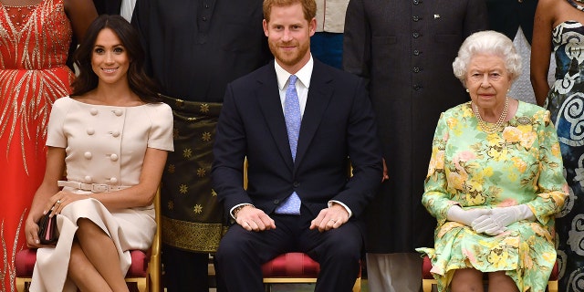 Meghan Markle, Prince Harry and Queen Elizabeth II at the Queen's Young Leaders Awards Ceremony at Buckingham Palace on June 26, 2018, in London.