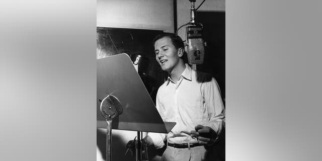 American actor and singer Pat Boone records a song, circa 1957.