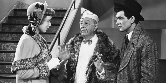 Samuel Fulton (Charles Coburn) interrupts a quarrel between Millicent Blaisdell (Piper Laurie) and her boyfriend Dan Stebbins (Rock Hudson) in the 1952 comedy film "Has Anybody Seen My Gal?"