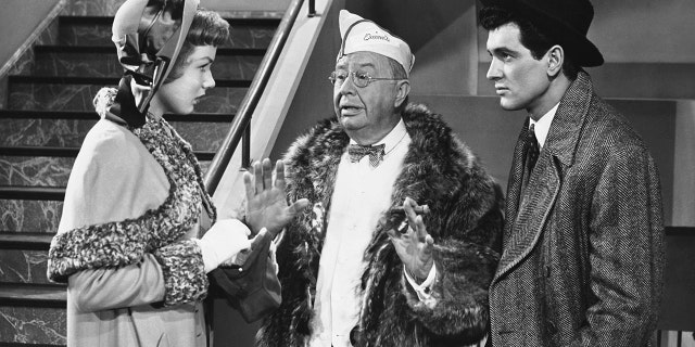 Samuel Fulton (Charles Coburn) interrupts a quarrel between Millicent Blaisdell (Piper Laurie) and her boyfriend Dan Stebbins (Rock Hudson) in the 1952 comedy film "Has Anybody Seen My Gal?"