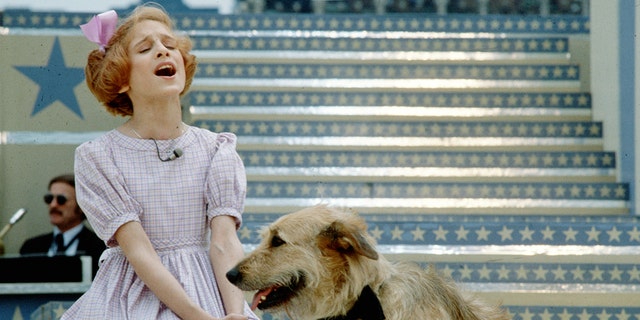 Actress Sarah Jessica Parker performs a scene with a dog in the musical 