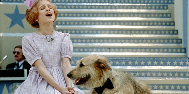 Actress Sarah Jessica Parker performs a scene with a dog in the musical 