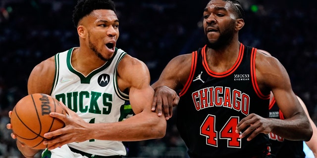 Milwaukee Bucks' Giannis Antetokounmpo tries to get past Chicago Bulls' Patrick Williams during the first half of Game 1 of their first round NBA playoff basketball game Sunday, April 17, 2022, in Milwaukee.