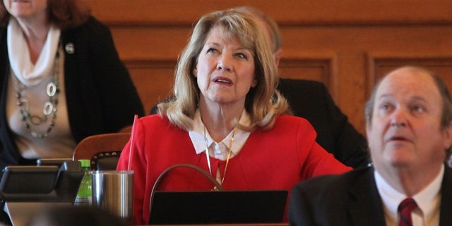 Kansas State Rep. Cheryl Helmer keeps an eye on one of Parliament's electronic tally boards during a vote on Tuesday, April 26, 2022, at the State House in Topeka, Kan. Helmer has publicly complained about having to share women's toilets with a transgender colleague.