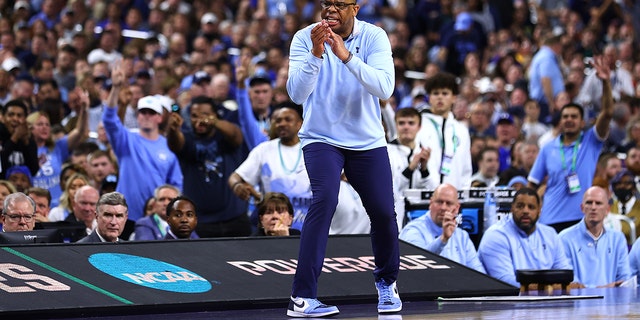 Head coach Hubert Davis of the North Carolina Tar Heels coaches from the bench as they take on the Duke Blue Devils during the first half in the semifinal game of the 2022 NCAA Men's Basketball Tournament Final Four at Caesars Superdome on April 02, 2022 in New Orleans, Louisiana.