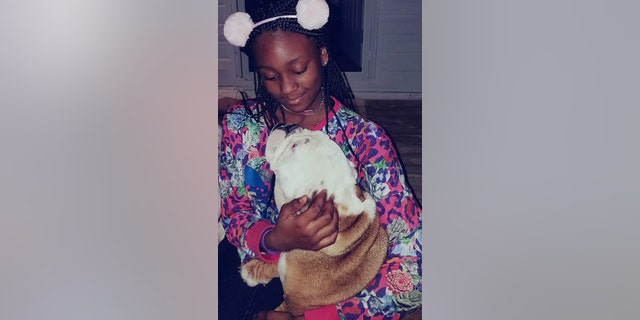 Naomi Jones, seen here with the family dog, was described as an obedient child who was always with her siblings.