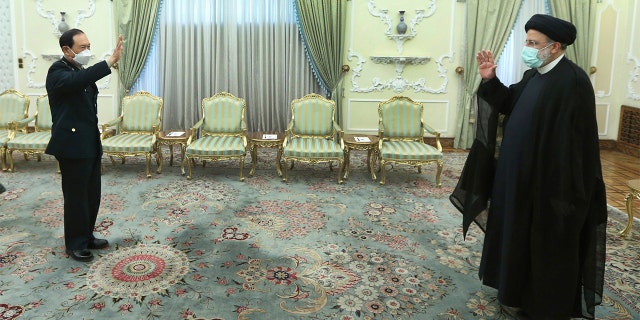 In this photo released by the official website of the office of the Iranian Presidency, President Ebrahim Raisi, right, and China's minister of national defense Gen. Wei Fenghe greet at the start of their meeting at the presidency office in Tehran, Iran, Wednesday, April 27, 2022.