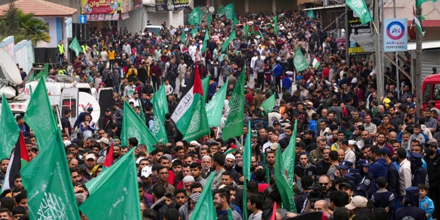 Hamas supporters wave green Islamic flags during a rally in solidarity with Palestinian residents of the West Bank and Jerusalem, at the main road of Jebaliya refugee camp, northern Gaza Strip, Friday, April 22, 2022. 