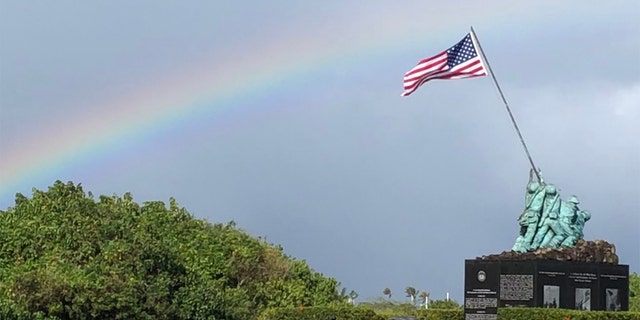 Marine Corps Air Station Kaneohe Bay entrance, Pacific WWII War Memorial underneath a rainbow, in Oahu, Hawaii, Feb. 2019. (iStock)