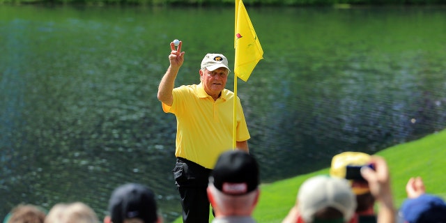 Patrons watch as Jack Nicklaus celebrates his hole-in-one on the fourth hole during the Par 3 Contest prior to the start of the 2015 Masters Tournament at Augusta National Golf Club on April 8, 2015 in Augusta, Georgia. 