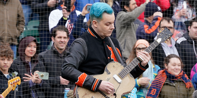 FILE - Musician Jack White performs the national anthem before the first inning of a baseball game between the Detroit Tigers and the Chicago White Sox, Friday, April 8, 2022, in Detroit. White surprised fans by marrying musician Olivia Jean on stage during his Detroit homecoming show Friday. The Detroit-born singer, songwriter and producer invited Jean onstage to join his performance and introduced her as his girlfriend. (AP Photo/Carlos Osorio, File)