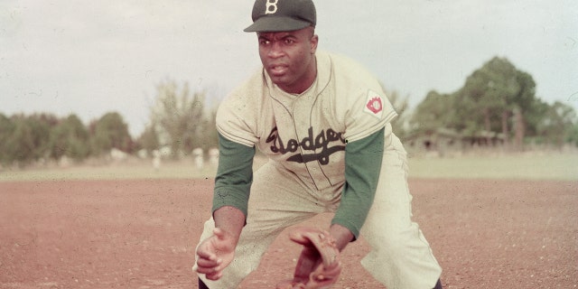 Jackie Robinson of the Brooklyn Dodgers prepares to catch a ball, 1951.