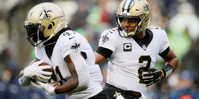 Jameis Winston (2) of the New Orleans Saints hands off to Alvin Kamara (41) against the Seattle Seahawks at Lumen Field Oct. 25, 2021, in Seattle.