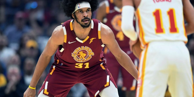 Cleveland Cavaliers' Jarrett Allen (31) defends Atlanta Hawks Trae Young (11) during the first half of an NBA play-in basketball game Friday, April 15, 2022, in Cleveland.
