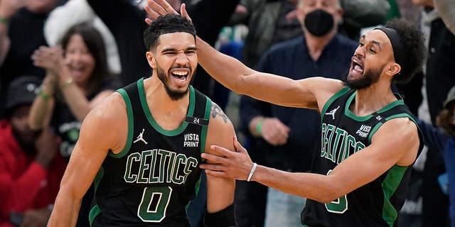 Boston Celtics forward Jayson Tatum (0) celebrates with guard Derrick White (9) after making a layup at the buzzer to score and win Game 1 of an NBA basketball first-round Eastern Conference playoff series against the Brooklyn Nets, Sunday, April 17, 2022, in Boston. The Celtics won 115-114.
