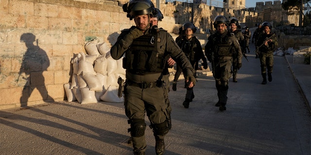 Israeli security forces gather during clashes with Palestinian demonstrators on the grounds of the Al-Aqsa Mosque in the Old City of Jerusalem on Friday, April 15, 2022.  (AP Photo/Mahmoud Illean)