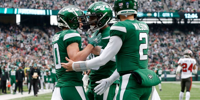Braxton Berrios (10) of the New York Jets celebrates his first quarter touchdown against the Tampa Bay Buccaneers with teammates Zach Wilson (2) and Jeff Smith (16) at MetLife Stadium Jan. 2, 2022, in East Rutherford, N.J.
