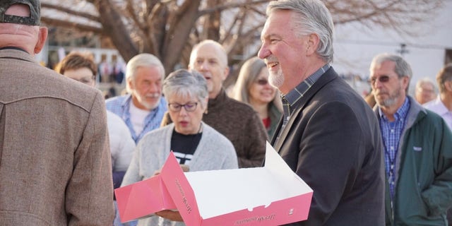 Republican Senate candidate Joe O'Dea hands out doughnuts to voters outside the state GOP assembly, on April 9, 2022, in Colorado Springs, Colorado.