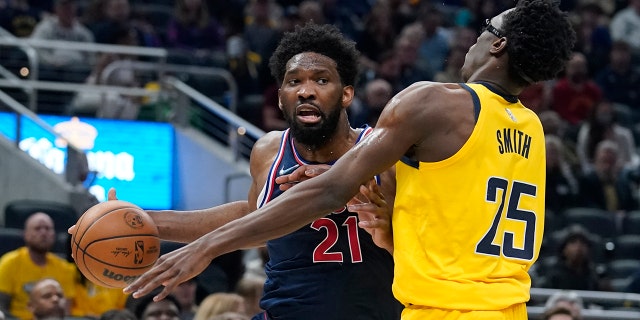 Philadelphia 76ers' Joel Embiid goes to the basket against Indiana Pacers' Jalen Smith during the first half of an NBA basketball game Tuesday, April 5, 2022, in Indianapolis.