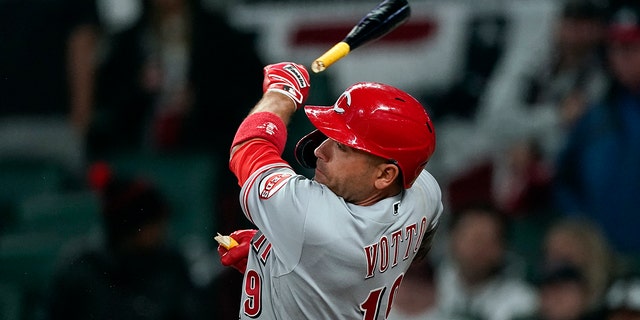 Cincinnati Reds' Joey Votto breaks his bat as he fouls off a pitch during the ninth inning of the team's baseball game against the Atlanta Braves on Saturday, April 9, 2022, in Atlanta.