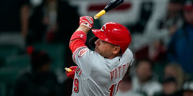 Cincinnati Reds' Joey Votto breaks his bat as he fouls off a pitch during the ninth inning of the team's baseball game against the Atlanta Braves on Saturday, April 9, 2022, in Atlanta.