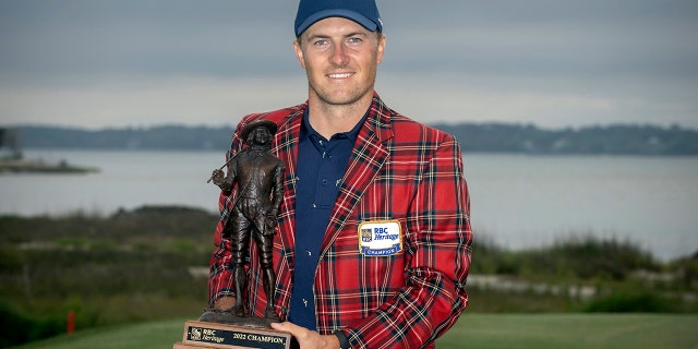Jordan Spieth holds the championship trophy after winning the RBC Heritage golf tournament, Sunday, April 17, 2022, in Hilton Head Island, South Carolina.