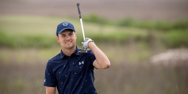 Jordan Spieth celebrates from the front bunker after chipping in at the 18th hole during the final round of the RBC Heritage golf tournament, Sunday, April 17, 2022, in Hilton Head Island, South Carolina.